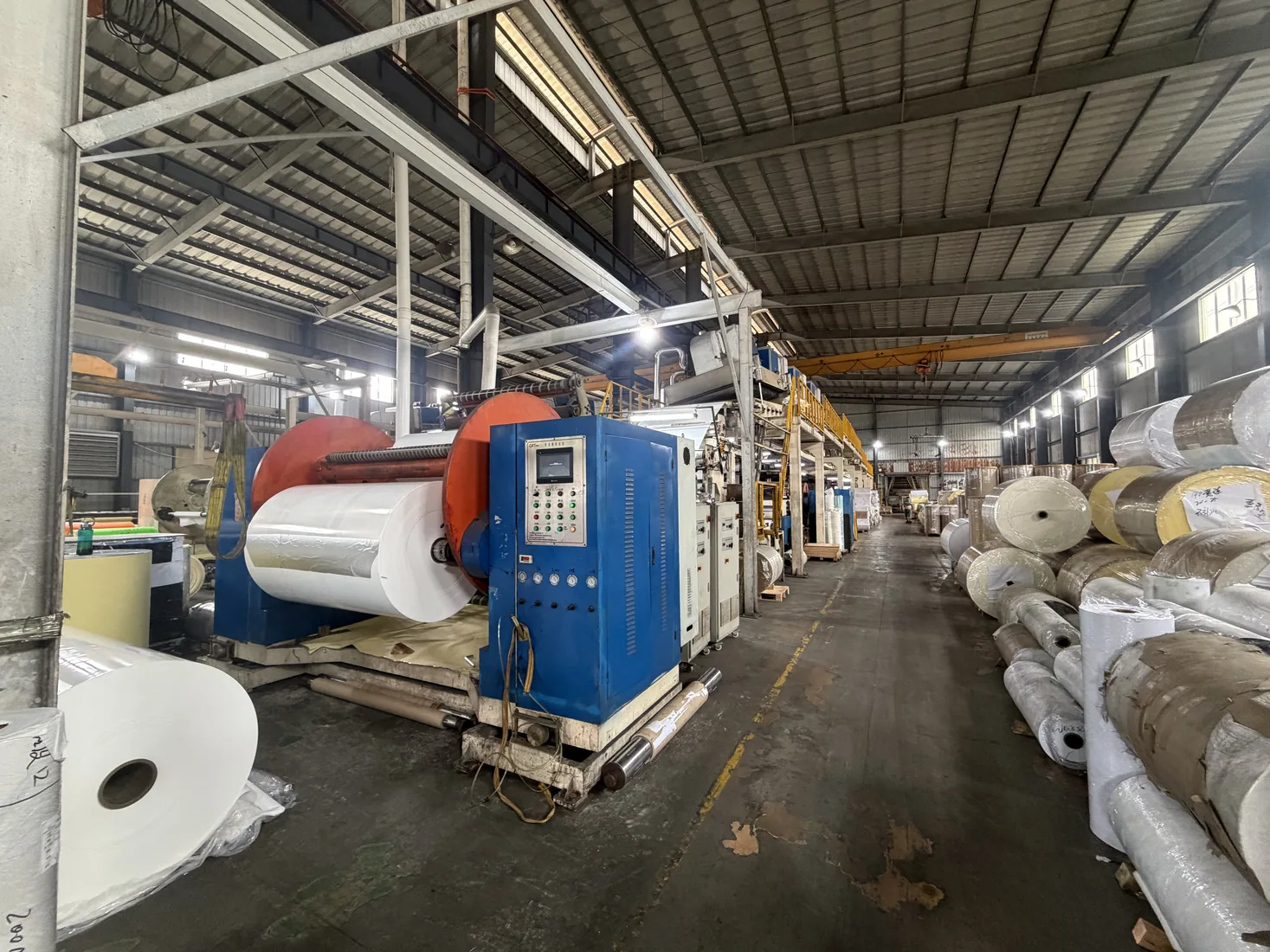 Factory production line with jumbo roll handling and material flow