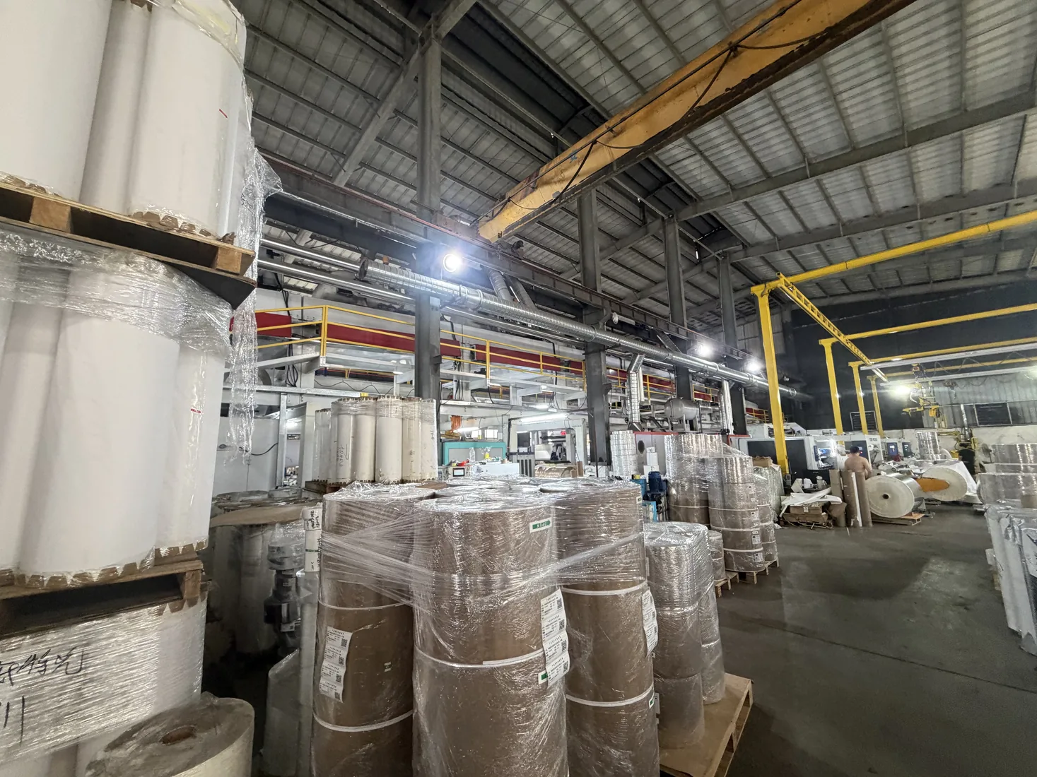 Workshop storage area showing wrapped rolls and production materials