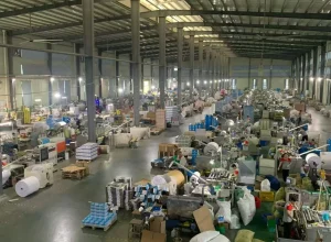 Production workshop with workers and packaging materials